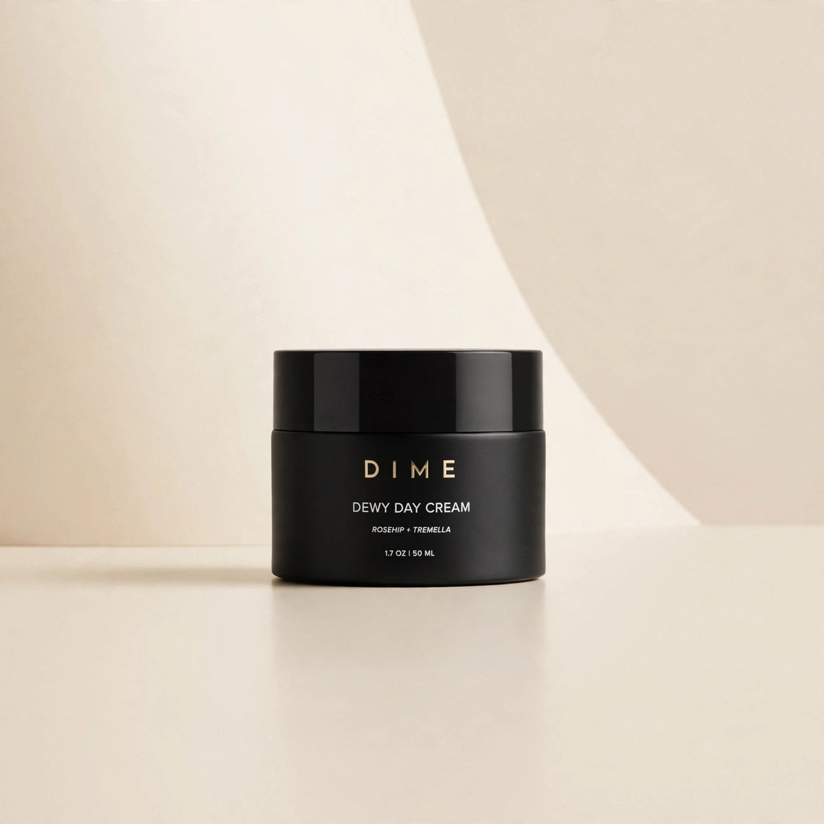 DIME Beauty Dewy Day Cream jar in a cream studio